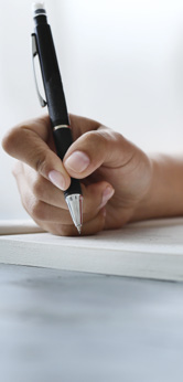 Hand writing with a pen on paper